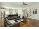 An open-concept living room flows into the kitchen with a large leather sectional and hardwood floors at 172 Olympic Pl, Decatur, GA 30030