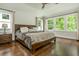 Charming main bedroom featuring hardwood floors, neutral decor, and large windows at 172 Olympic Pl, Decatur, GA 30030