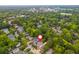 Aerial shot of a lush neighborhood with tree-lined streets in a desirable location; the property has a red pin at 172 Olympic Pl, Decatur, GA 30030