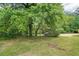 Enjoy this property with a sprawling backyard shaded by mature trees at 1960 W Hightower Trl, Conyers, GA 30012