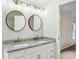 Bright bathroom featuring a double vanity with granite countertops, modern fixtures, and ample cabinet space at 1960 W Hightower Trl, Conyers, GA 30012