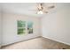 Bedroom featuring neutral carpeting, paneled walls, and large windows for natural light at 1960 W Hightower Trl, Conyers, GA 30012