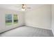 Bright, airy bedroom with neutral carpet and large windows overlooking the yard at 1960 W Hightower Trl, Conyers, GA 30012