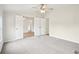 Neutral bedroom with a ceiling fan, soft carpet, and double doors leading to another room, enhancing the home's flow at 1960 W Hightower Trl, Conyers, GA 30012