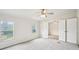 Bright bedroom featuring neutral carpet, ceiling fan, and double windows offering a view of the home's front yard at 1960 W Hightower Trl, Conyers, GA 30012