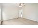 This bedroom features neutral carpeting, a ceiling fan, and paneled walls at 1960 W Hightower Trl, Conyers, GA 30012