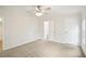 This bedroom features neutral carpeting, a ceiling fan, and paneled walls at 1960 W Hightower Trl, Conyers, GA 30012