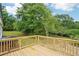 Newly constructed wooden deck with railing overlooks the private backyard at 1960 W Hightower Trl, Conyers, GA 30012