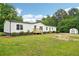 Attractive single-story home with white siding, landscaping, and detached shed at 1960 W Hightower Trl, Conyers, GA 30012