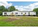 Charming single-story home with white siding and a well-maintained front yard at 1960 W Hightower Trl, Conyers, GA 30012