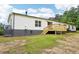 Exterior of home with new deck and spacious backyard on a sunny day at 1960 W Hightower Trl, Conyers, GA 30012