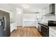 Open-concept kitchen with white cabinets, stainless appliances, and granite countertops at 1960 W Hightower Trl, Conyers, GA 30012