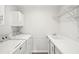 Laundry room featuring a washing machine, dryer, sink and overhead shelving at 1960 W Hightower Trl, Conyers, GA 30012