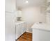 Laundry room featuring a washing machine, dryer, sink and built-in shelving at 1960 W Hightower Trl, Conyers, GA 30012