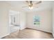 Light-filled living room with wood-look flooring, a view of the front yard, and an open floor plan at 1960 W Hightower Trl, Conyers, GA 30012