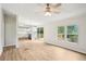 Open-concept living area with wood flooring, white walls, and easy access to the kitchen at 1960 W Hightower Trl, Conyers, GA 30012