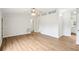 Open-concept living room with wood flooring, white walls, and modern ceiling fan at 1960 W Hightower Trl, Conyers, GA 30012