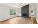Sunlit living room featuring a fireplace, windows, and light wood flooring at 1960 W Hightower Trl, Conyers, GA 30012