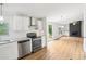 Open floor plan between kitchen and living room with fireplace and wood floors at 1960 W Hightower Trl, Conyers, GA 30012