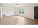 Comfortable living room with wood flooring, neutral walls, and large windows at 1960 W Hightower Trl, Conyers, GA 30012