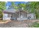 Backyard with a view of the rear exterior of the house with a screened-in porch at 1965 Tiner Ct, Cumming, GA 30041