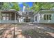 Backyard view of the home with a screened-in porch and deck with a hot tub at 1965 Tiner Ct, Cumming, GA 30041