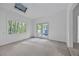 Bedroom with skylight, carpet flooring, and access to patio at 1965 Tiner Ct, Cumming, GA 30041