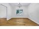 Elegant dining room with hardwood floors, white walls, a modern light fixture, and a large window at 1965 Tiner Ct, Cumming, GA 30041