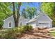 Beautiful one-story home with a large tree, a two-car garage, and attractive architectural details at 1965 Tiner Ct, Cumming, GA 30041