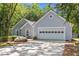 Lovely one-story home featuring a two-car garage, a mature tree, and a well-manicured lawn at 1965 Tiner Ct, Cumming, GA 30041