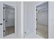 Hallway showing a tiled shower stall, walk-in closet with shelving, and bedroom entrance at 1965 Tiner Ct, Cumming, GA 30041