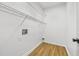 Laundry room with white walls, wood-look flooring, and wire shelving at 1965 Tiner Ct, Cumming, GA 30041