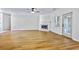 Open living space with hardwood floors, white trim, a fireplace, and a door to the outside at 1965 Tiner Ct, Cumming, GA 30041