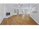 Bright and airy living room with hardwood flooring, a fireplace, large windows and recessed lighting at 1965 Tiner Ct, Cumming, GA 30041