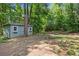 Exterior view of the backyard shed with small window boxes and a fire pit nearby at 1965 Tiner Ct, Cumming, GA 30041