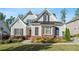Inviting two-story home with light-gray siding, brick accents, manicured lawn, and beautiful landscaping at 2208 Sage Mountain Sw Ct, Marietta, GA 30064