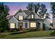 Charming two-story home with gray siding, brick accents, and manicured lawn set against a twilight sky at 2208 Sage Mountain Sw Ct, Marietta, GA 30064