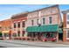 Charming brick buildings with outdoor seating under green awnings, creating a welcoming commercial space at 2208 Sage Mountain Sw Ct, Marietta, GA 30064