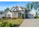 Beautiful two-story home with light-gray siding, brick accents, attached garage, and long driveway at 2208 Sage Mountain Sw Ct, Marietta, GA 30064