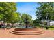 Picturesque park fountain on a sunny day, surrounded by shade trees and brick sidewalks at 2208 Sage Mountain Sw Ct, Marietta, GA 30064
