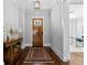 Elegant foyer featuring hardwood floors, wooden front door, console table, and view into office space at 2208 Sage Mountain Sw Ct, Marietta, GA 30064