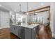 Bright kitchen with an island, quartz countertops, stainless steel appliances, and an open layout at 2208 Sage Mountain Sw Ct, Marietta, GA 30064