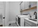 Efficient laundry room with modern appliances and ample storage space at 2208 Sage Mountain Sw Ct, Marietta, GA 30064