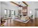 Spacious living room with hardwood floors, exposed beams, brick fireplace, and access to outdoor space at 2208 Sage Mountain Sw Ct, Marietta, GA 30064