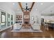 Open-concept living space with hardwood floors, brick fireplace, and seamless flow into the kitchen area at 2208 Sage Mountain Sw Ct, Marietta, GA 30064