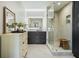 Modern bathroom features sleek vanity, a mirror with LED lighting, and a frameless walk-in shower with seat at 890 Memorial Se Dr # 102, Atlanta, GA 30316