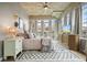 Bright bedroom featuring large windows, neutral décor, and stylish furnishings with decorative rug at 890 Memorial Se Dr # 102, Atlanta, GA 30316