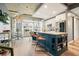 A kitchen with blue cabinets and a large island with seating for three, accented by a large window and modern appliances at 890 Memorial Se Dr # 102, Atlanta, GA 30316