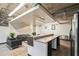 Stylish lounge area with modern furnishings, an island bar, and a stainless steel refrigerator at 890 Memorial Se Dr # 102, Atlanta, GA 30316