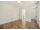 Bright bedroom with wood flooring and white walls leading to hallway and closet at 2200 Carlton Ct # 6, Atlanta, GA 30318